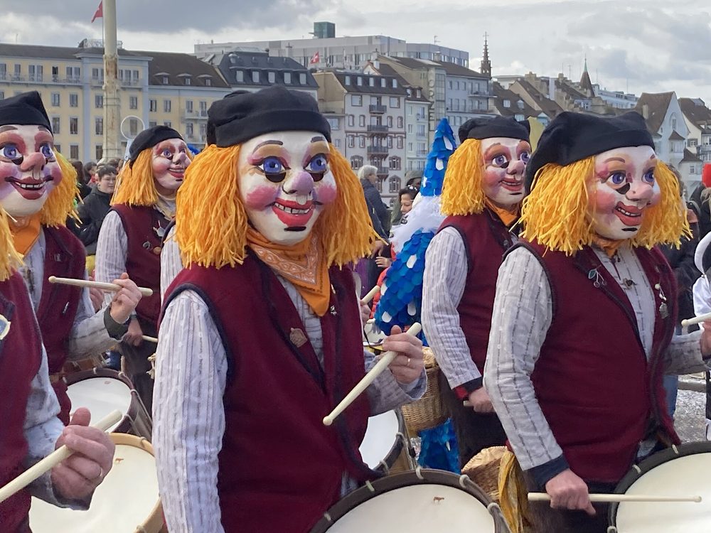Masked drummers in costume marching through Basel