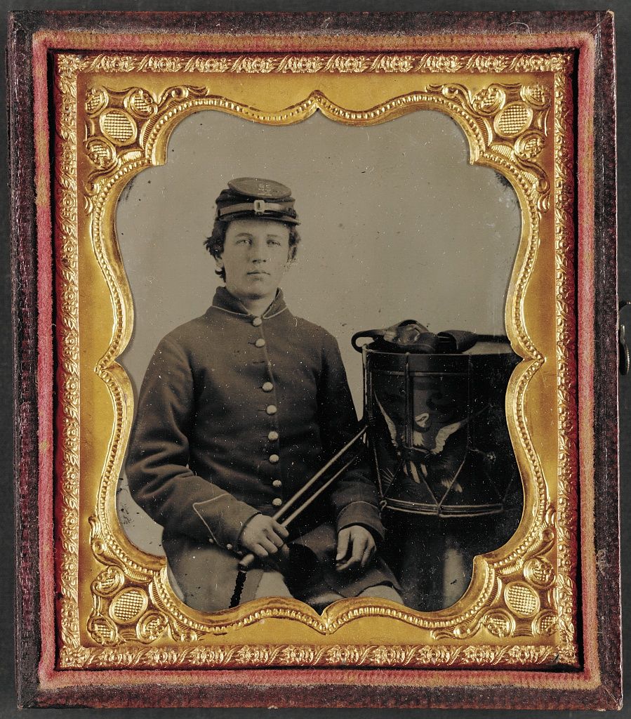 A tintype portrait of a young drummer in Union uniform with his drum